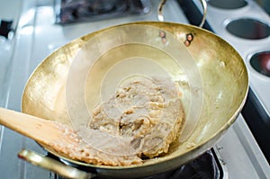 Crushed taro in brass pan prepare for making thai dessert