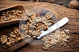 Crushed walnut nuts kernels and knife