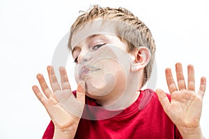 Crushed young boy touching his goofy face to a window