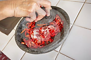 Crushing chillies