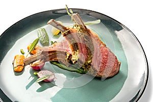 Crusted lamb ribs cutlets in green dish