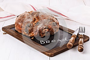 Crusty bread on white wooden background