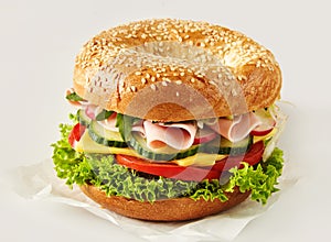 Crusty sesame bun with ham, cheese and salad