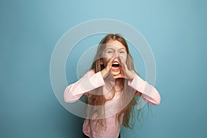 The cry. Teen girl on a blue background. Facial expressions and people emotions concept