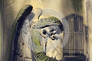 Crying angel organist tombstone on Malostransky cemetery, Prague, Czech republic