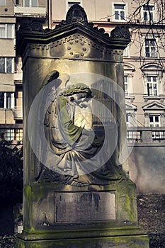 Crying angel organist tombstone on Malostransky cemetery, Prague, Czech republic