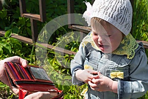 Crying baby with empty purse