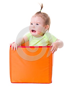 Crying baby girl sitting in box