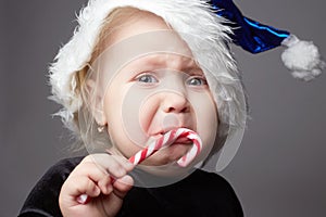 Crying baby. kid with candy. sad child in christmas time