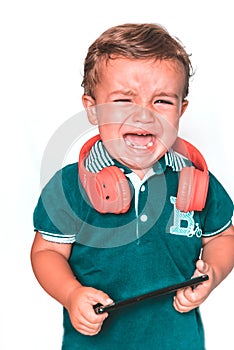 Crying child with red neckband and blue polo shirt photo