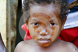 Crying girl with tear on cheek - poor african child