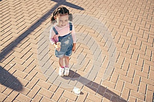 Crying kid drop ice cream on floor, ground and street in summer, sunshine and outdoors. Sad, unhappy and frustrated girl