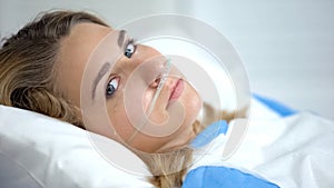 Crying lady with oxygen nasal cannula looking at camera, worrying before surgery