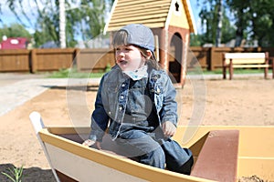 Crying little boy on playpit