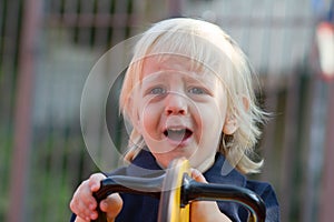 Crying little child on playground