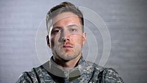 Crying male soldier looking at camera, military posttraumatic syndrome, problem photo