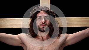 Crying Messiah in crown thorns, sacrificing life, suffering crucifix, religion