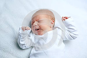 Crying newborn baby boy or girl on changing table