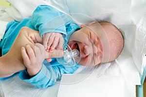 Crying newborn baby infant in the hospital