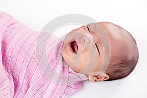Crying newborn baby on soft cloth