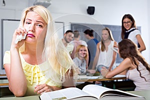 Crying outcast student in college classroom