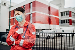 Crying paramedic in front of isolation hospital facility.Mental melt down of medical professional.Emergency room doctor in fear photo