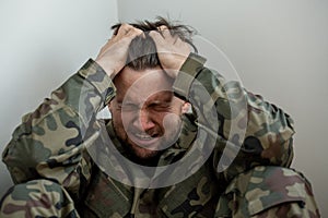 Crying professional soldier with depression and trauma after war photo