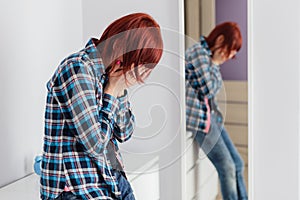 Crying scared redhead woman