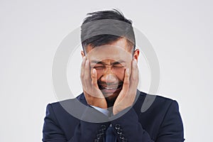 Crying, stress or sad businessman in studio with anxiety, worry or debt risk on grey background. Pain, sorrow or