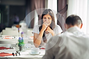 Crying stressed woman in fear,having a conversation with a man about problems.Reaction to negative event,handling bad news