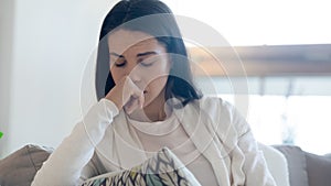 Crying teenage female sitting on couch upset of heartbreak photo