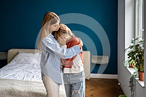 Crying upset teen girl child sharing feelings with mother, loving supportive mom hugging daughter