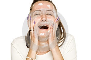 Crying woman applying face cream