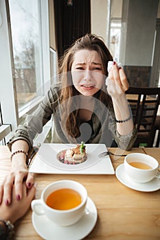 Crying woman in cafe