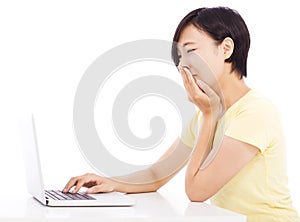 Crying woman in front of a laptop, isolated on white