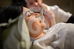 Crying woman giving birth at home