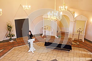 Crying woman near coffin at funeral in church