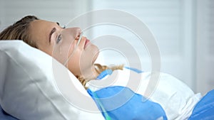 Crying woman with oxygen nasal catheter, worrying before important operation