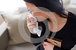 Crying woman with photo frame at funeral day