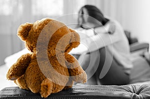 Crying woman and teddy bear. Lonely life concept