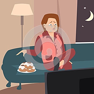 Crying woman watching tv and eating cookies