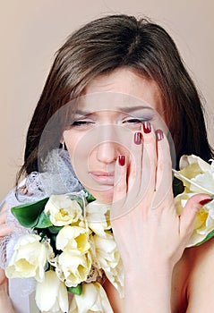 Crying woman with white flowers tulips