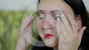 A crying woman wipes tears from her eyes.