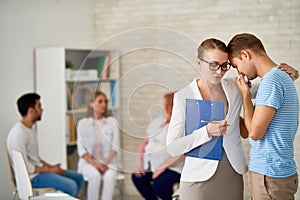 Crying Young Man at Group Therapy Session