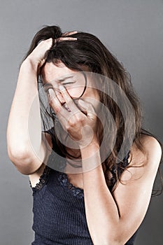 Crying young woman expressing despair and sorrow