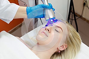 Cryotherapy for facial skin rejuvenation in a beauty salon.