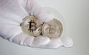 Crypto currency bitcoin on hand in white glove 2