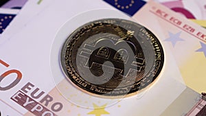 Crypto Currency Concept, Bitcoin Golden Coin on 50 Euro Banknote, Close Up Spin