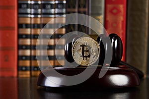 Crypto currency law, judge gavel, stacked legal book and bitcoin