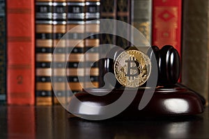 Crypto currency law, judge gavel, stacked legal book and bitcoin